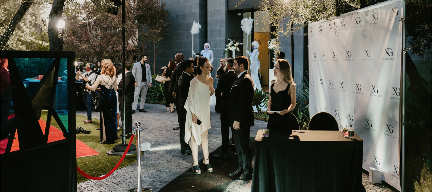 Evening reception with red carpet and photo wall at a private venue